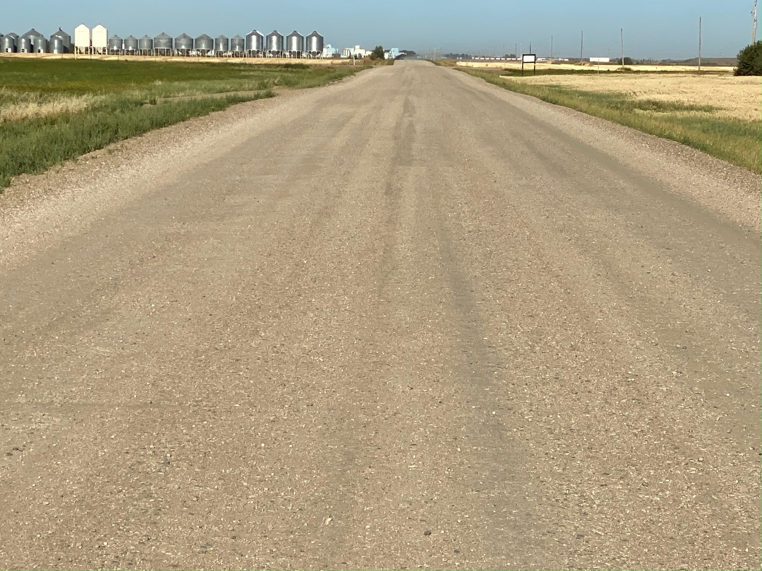 Graded rural roadway past a grain terminal