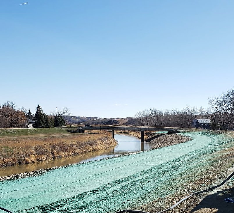 Hydro-seeded slope beside a watercourse