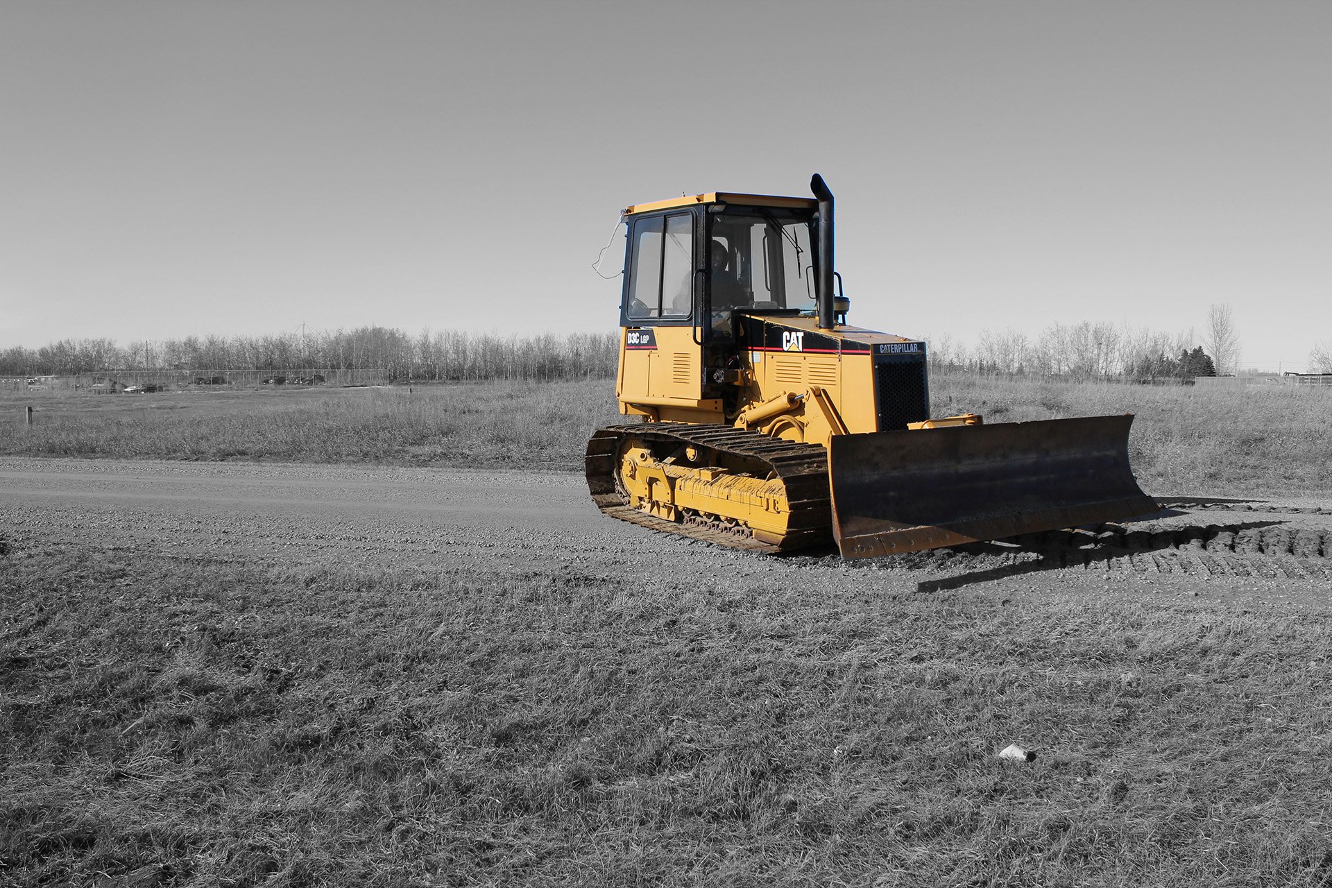 Cat D3 LGP dozer grading a field